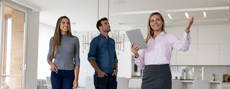 Realtor showing a couple a modern condo