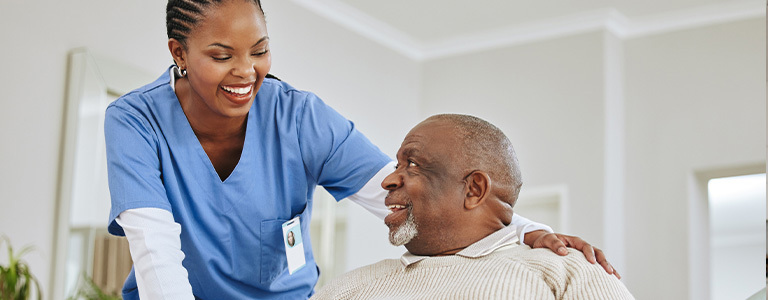 Image of smiling nurse helping older man