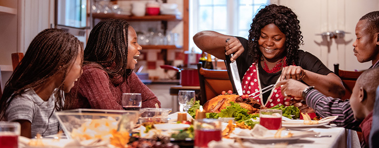 Family laughing and having thanksgiving dinner