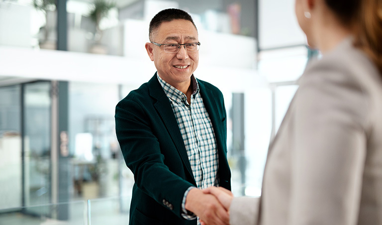 Man shaking hands with woman after interview