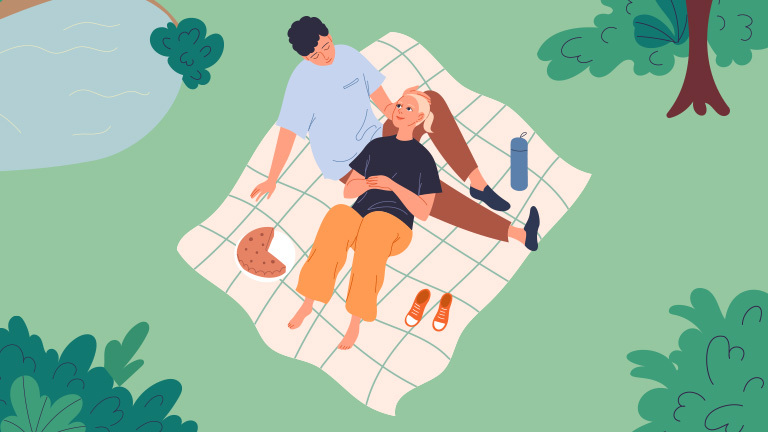 Couple on picnic blanket at park