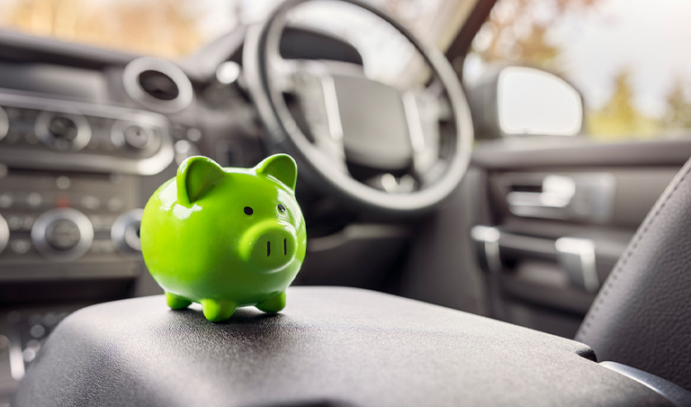 green piggy bank sitting in car