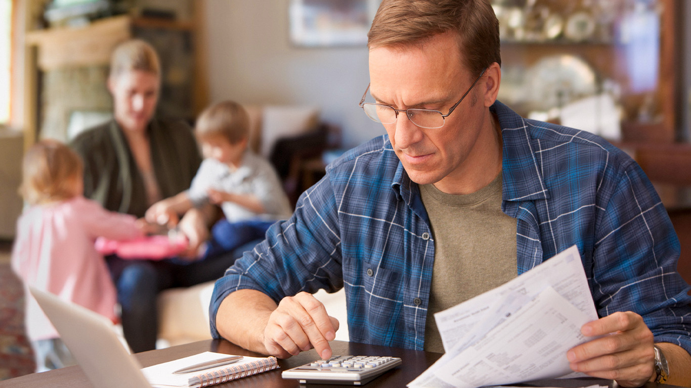 A man reviewing his bills and making calculations